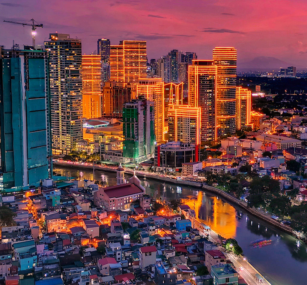 High angle view of illuminated buildings during sunset in Makati City, Philippines.